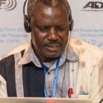 A small image of Dr. Iga Daniel Mwesigwa
